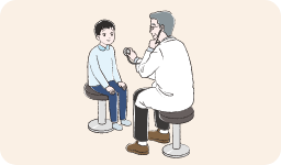 病院で男性医師の診察を受けている男の子のイラスト