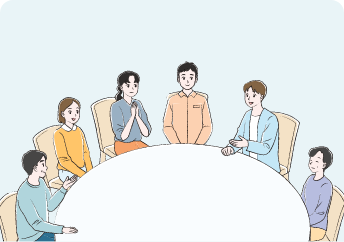 丸テーブルを囲んで男女6名の参加者が話をしている患者会の様子